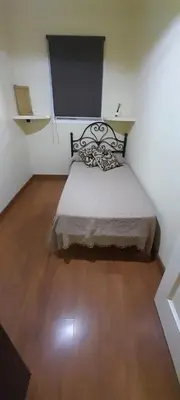 a small bedroom with a bed in a room at Emperador Carlos in San Fernando