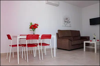 a living room with a table and chairs and a couch at Casa Rural Zara I in Conil de la Frontera