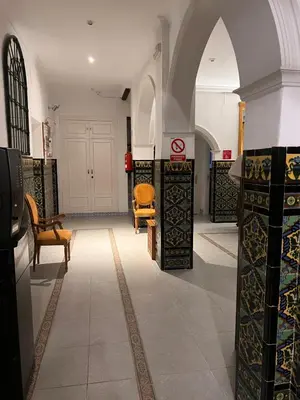 a room with chairs and tables in a building at Hostal Playa Hidalgo in Rota