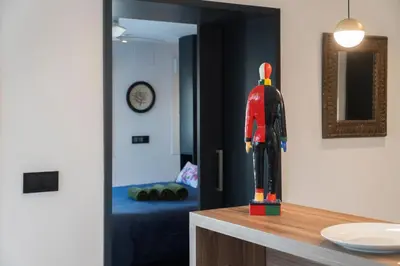 a wooden mannequin on a counter next to a bedroom at Ático Plata in Cádiz