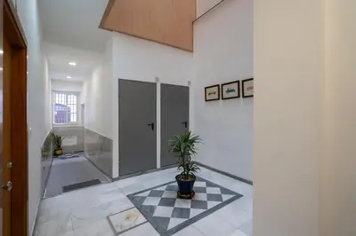 a hallway with a potted plant on a checkered floor at Ático Plata in Cádiz