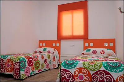 a bedroom with two beds and a window at Casa Rural Zara III in Conil de la Frontera