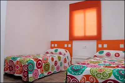 a room with two beds and a window at Casa Rural Zara III in Conil de la Frontera