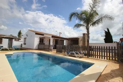 a swimming pool in front of a house at Casa Jorge in Conil de la Frontera