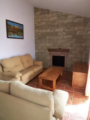 a living room with a couch and a fireplace at Casa Jorge in Conil de la Frontera