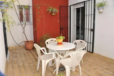 a white table and chairs on a patio at Hostal La Andaluza in San Fernando