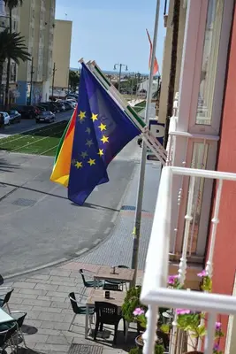 a flag is flying in front of a building at Hostal La Andaluza in San Fernando