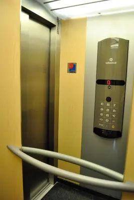an elevator with a cell phone on the wall at Hostal La Andaluza in San Fernando