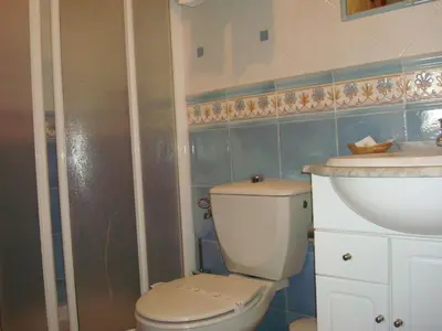 a bathroom with a toilet and a sink at Hotel Restaurante El Duque in Medina Sidonia