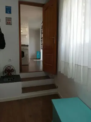 a hallway with a door and stairs in a house at Atico SIROCO in Sanlúcar de Barrameda