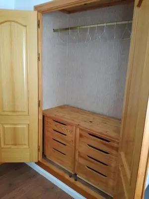 a closet with a wooden dresser in a room at Atico SIROCO in Sanlúcar de Barrameda