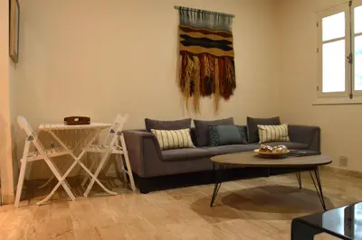 a living room with a couch and a table at Apartamento El Balneario in Cádiz