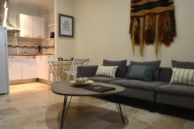 a living room with a couch and a table at Apartamento El Balneario in Cádiz