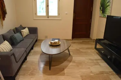 a living room with a couch and a coffee table at Apartamento El Balneario in Cádiz