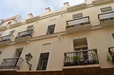 a large white building with balconies at Apartamento El Balneario in Cádiz