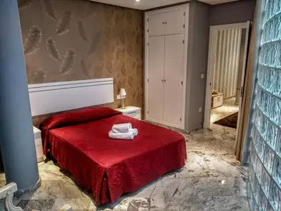 two beds in a room with a wallpaper at Apartamentos El Vestuario in Cádiz