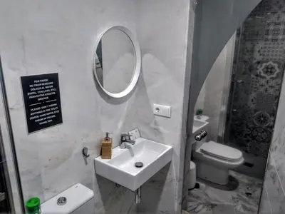 a living room with a flat screen tv and a table at Apartamentos El Vestuario in Cádiz