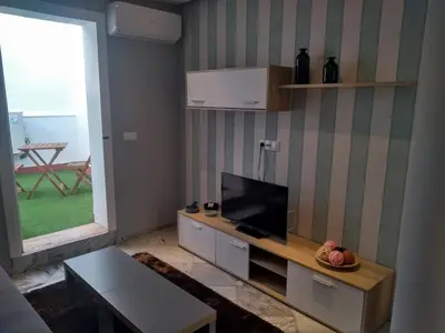 a bathroom with blue and white tiled walls and a sink at Apartamentos El Vestuario in Cádiz
