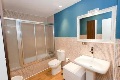 a bathroom with a toilet and a sink and a mirror at Dúplex tipo Loft - Parking opcional in Jerez de la Frontera