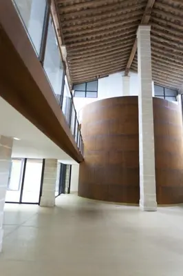 an empty room with a large wooden wall and windows at Dúplex tipo Loft - Parking opcional in Jerez de la Frontera