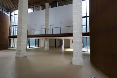 a large room with columns and a balcony in a building at Dúplex tipo Loft - Parking opcional in Jerez de la Frontera