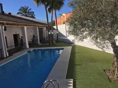 a swimming pool in the backyard of a house at Dúplex tipo Loft - Parking opcional in Jerez de la Frontera