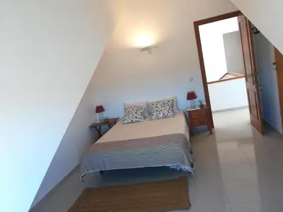 a bedroom with a bed with pillows on it at Casa Algaida in Sanlúcar de Barrameda