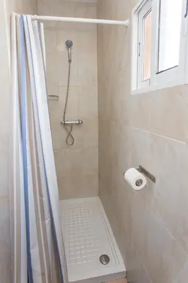 a bathroom with a shower with a roll of toilet paper at Casa Jerez Alameda del Banco in Jerez de la Frontera