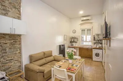 a living room with a couch and a table at Casa Jerez Alameda del Banco in Jerez de la Frontera