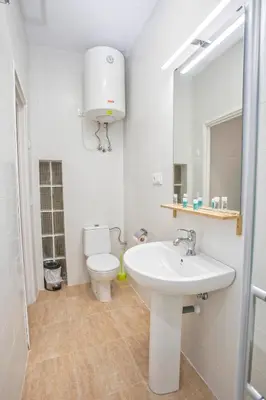 a white bathroom with a toilet and a sink at Casa Jerez Alameda del Banco in Jerez de la Frontera