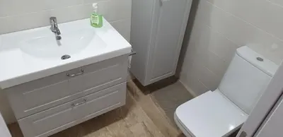 a bathroom with a white sink and a toilet at Taymar in Chiclana de la Frontera