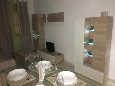 a kitchen with a glass table with plates on it at Casa de Corralón in Cádiz
