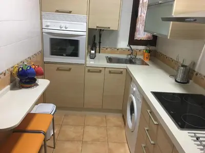 a small kitchen with a sink and a dishwasher at Casa de Corralón in Cádiz