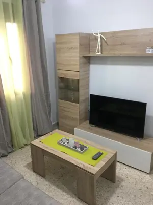 a living room with a tv and a coffee table at Casa de Corralón in Cádiz