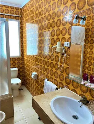 a bathroom with a sink and a toilet at Hotel Medina Centro in Jerez de la Frontera