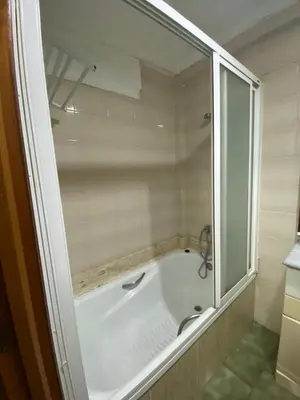 a bathroom with a bath tub with a glass window at Hotel Medina Centro in Jerez de la Frontera