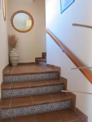 a set of stairs in a home with a mirror at Hotel Restaurante El Lago in Arcos de la Frontera