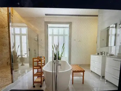 a bathroom with a bath tub and a table and chairs at CASA PALACIO en Jerez de la Frontera con piscina privada in Jerez de la Frontera