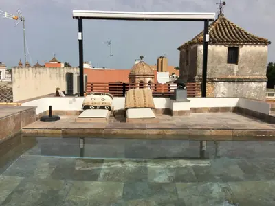 two chairs sitting on top of a roof at CASA PALACIO en Jerez de la Frontera con piscina privada in Jerez de la Frontera