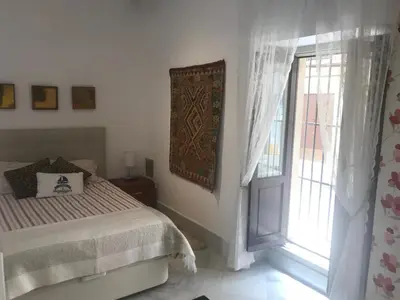 a bedroom with a bed and a window at CASA PALACIO en Jerez de la Frontera con piscina privada in Jerez de la Frontera