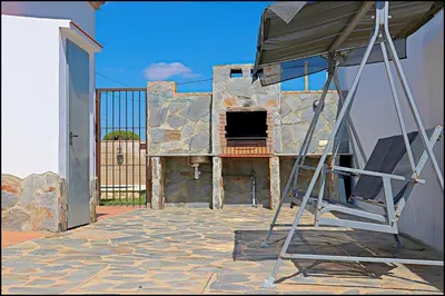 a ladder sitting on top of a stone building at Chalet Ruperto in Conil de la Frontera