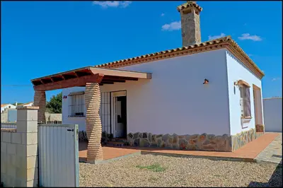 a small white house with a chimney at Chalet Ruperto in Conil de la Frontera