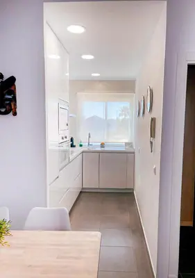 a white kitchen with a sink and a window at Sunny Sanlucar in Sanlúcar de Barrameda