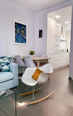 a living room with a couch and a table and chairs at Sunny Sanlucar in Sanlúcar de Barrameda