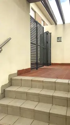 a set of stairs with a gate in a building at Sunny Sanlucar in Sanlúcar de Barrameda