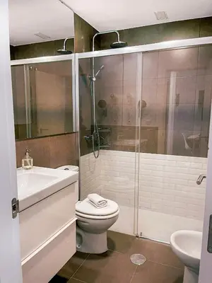 a bathroom with a toilet and a sink and a shower at Sunny Sanlucar in Sanlúcar de Barrameda