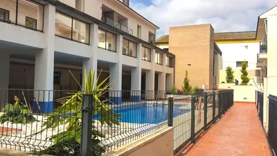 a swimming pool in the courtyard of a building at Sunny Sanlucar in Sanlúcar de Barrameda
