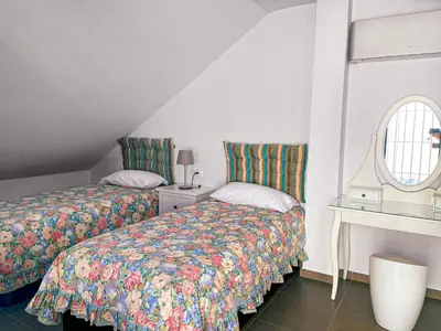 a bedroom with two beds and a window at Sunny Sanlucar in Sanlúcar de Barrameda