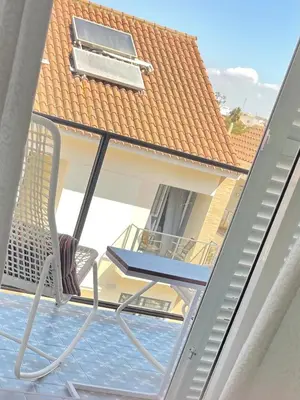 a chair on the balcony of a house at Sunny Sanlucar in Sanlúcar de Barrameda