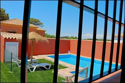 a view from a window of a house with a swimming pool at Chalet Maestro in Roche